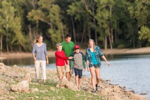 Family hiking alongside Table Rock Lake in Spring time.